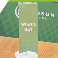 A close up of a table flag that says "What's up?".